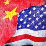 China Surpasses U.S. in Latin America Influence Chinese and American flags torn and overlapping