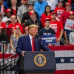 Cleveland to Get New Submarine Repair Center Donald Trump speaks at a rally podium; Christian Jones and Bear Pascoe are in the crowd behind him