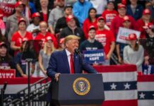 Cleveland to Get New Submarine Repair Center Donald Trump speaks at a rally podium; Christian Jones and Bear Pascoe are in the crowd behind him