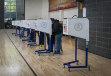 DOJ’s California Ballot Challenge Intensifies Voters at polling booths in a gymnasium
