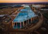Finland Orders Google Data Center Work Halted aerial view of large industrial building under construction at sunset