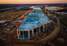 Finland Orders Google Data Center Work Halted aerial view of large industrial building under construction at sunset