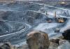 Accidents, Protests and Delays Put Copper Markets on Edge Open-pit mine with haul trucks and excavators on terraced roads