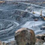 Accidents, Protests and Delays Put Copper Markets on Edge Open-pit mine with haul trucks and excavators on terraced roads