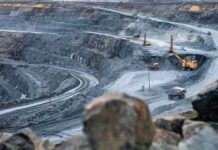 Accidents, Protests and Delays Put Copper Markets on Edge Open-pit mine with haul trucks and excavators on terraced roads