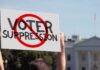 Hollywood Voices Join Fight Over Voting Rules Protester holding a sign in front of a government building