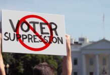 Hollywood Voices Join Fight Over Voting Rules Protester holding a sign in front of a government building