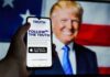 TV Host Walks Back Claim Smartphone showing Truth Social app screen with Donald Trump on a U.S. flag backdrop