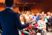 Speaker addressing an audience in a conference room