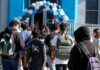 Birthplace, Schooling and the Politics of AOC’s Past Students with backpacks enter a school under a balloon arch