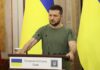 Trump Pushes for Ukraine-Russia Deal Man at a podium with Ukrainian flags