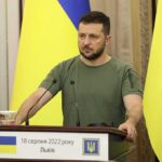 Trump Pushes for Ukraine-Russia Deal Man at a podium with Ukrainian flags