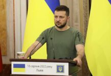 Trump Pushes for Ukraine-Russia Deal Man at a podium with Ukrainian flags
