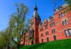 Historic red brick building with tower on a sunny day