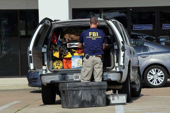 FBI evidence technician working at the open back of an SUV