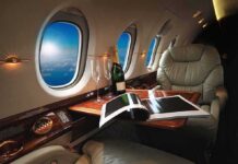 Air France Unveils Ultra-Luxury Travel Experience private jet cabin with leather seat, champagne and magazine on table