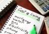Energy Costs Put Fresh Pressure on Inflation Budget notebook with cost of living list, calculator, and cash