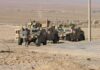 Egypt Considers Sending Troops to Saudi Arabia Soldiers near armored vehicles in a desert