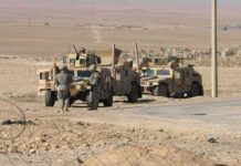 Egypt Considers Sending Troops to Saudi Arabia Soldiers near armored vehicles in a desert