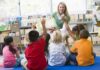 Teacher reading to children in a library circle